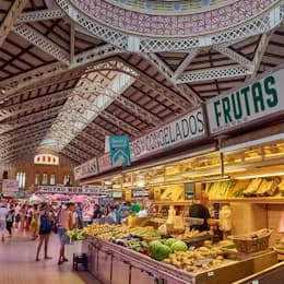 Fruit stalls under the tiled vaults of a covered market hall